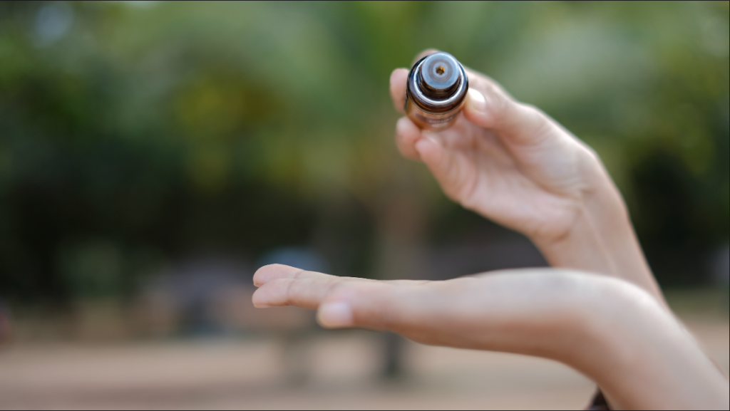 Pour essential oil in hand for topical usage.