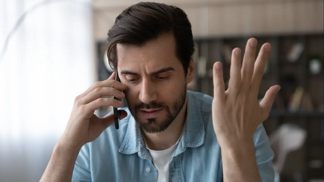Man upset at marketing call.