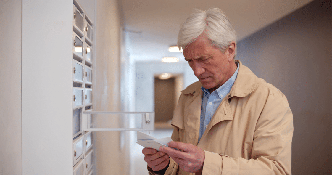 Man receiving notice of data breach in mail.
