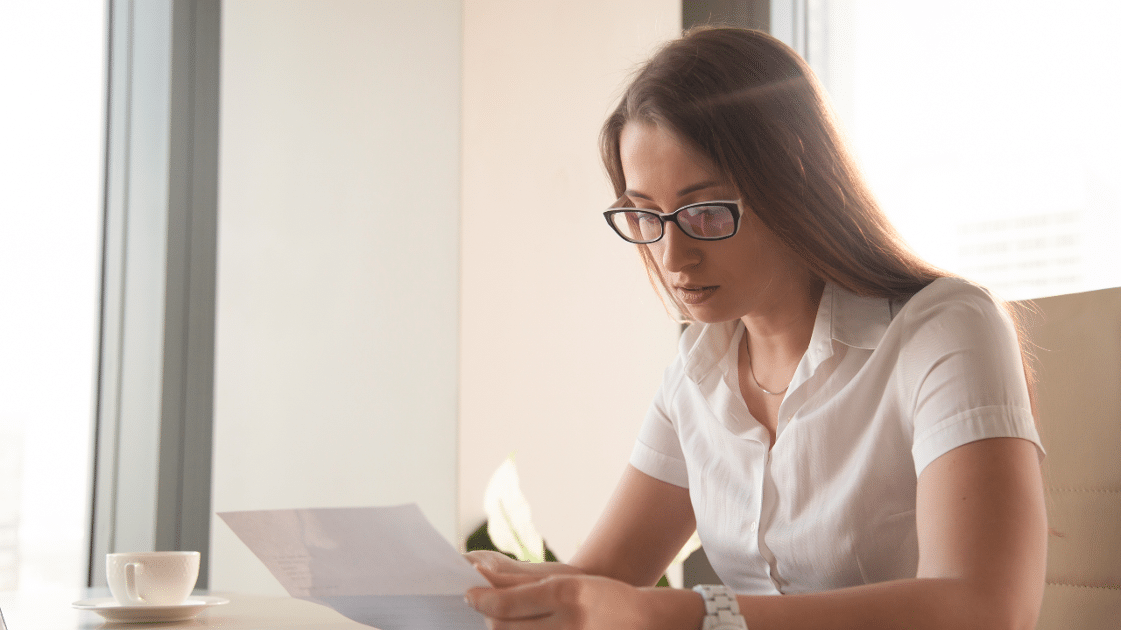 woman receiving past due notice of unknown debt.
