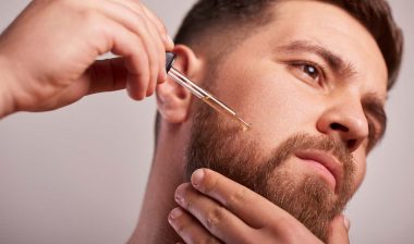 Close up of a man putting serum into his beard, representing the Beard Guyz class action.