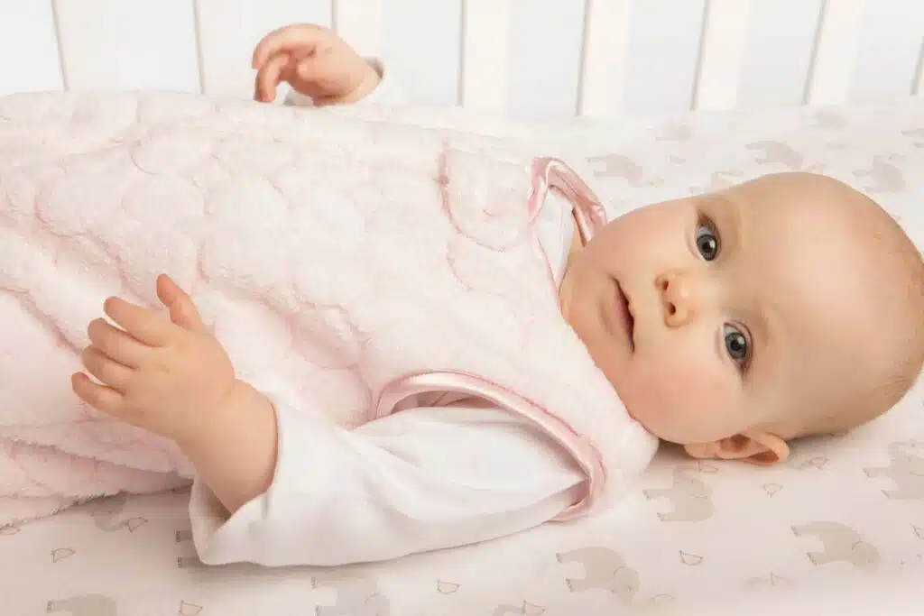 Close up of a baby in a sleep sack, representing the Dreamland class action.