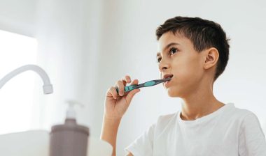A young boy brushing his teeth, representing the toothpaste PFAS class action.