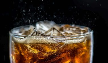 Close up of fizzy cola in a glass, representing the soft drink recall.