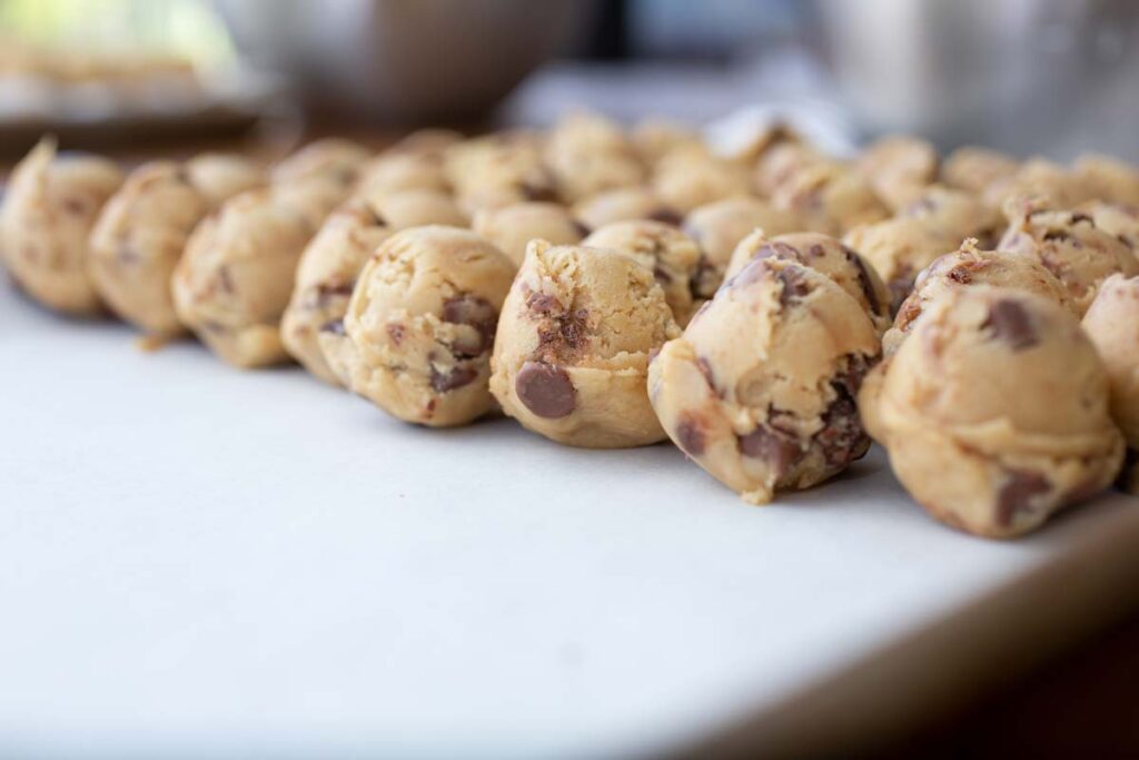 Close up of raw cookie dough on a cookie sheet, representing the cookie dough recall.