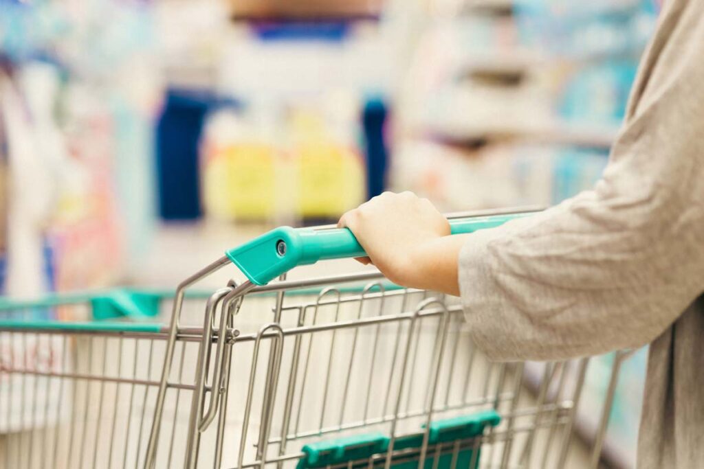 Close up of a woman pushing a shopping cart in a supermarket, representing top recalls for the week of June 3.