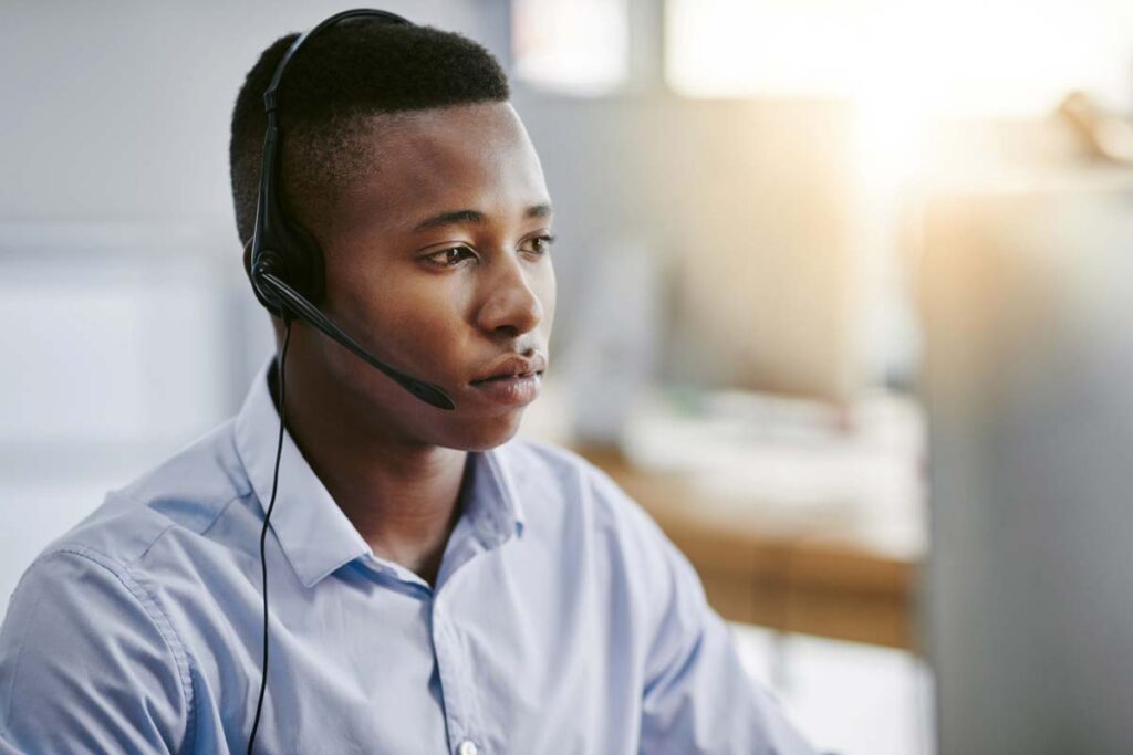 A debt collector wearing a headset while on a phone call, representing the debt collector class action.