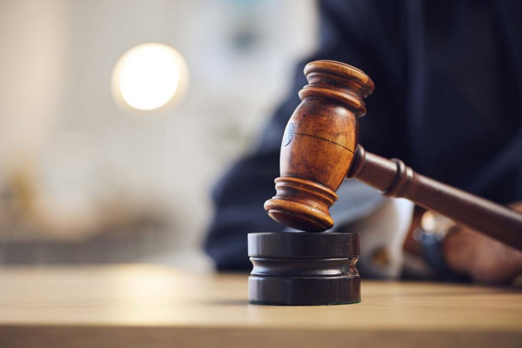 Close up of a wooden gavel being used in court, representing the PFAS class actions.