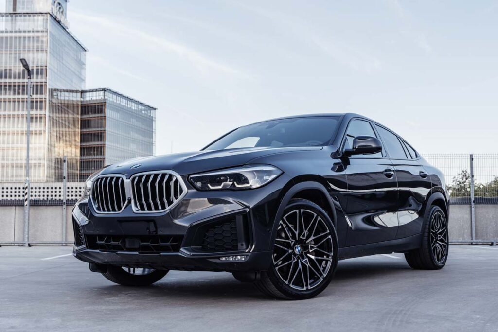 A black BMW X6 on a parking garage rooftop, representing the BMW class action.