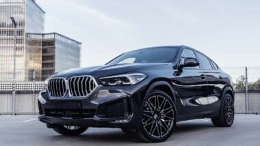 A black BMW X6 on a parking garage rooftop, representing the BMW class action.