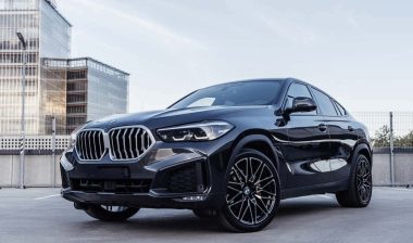 A black BMW X6 on a parking garage rooftop, representing the BMW class action.