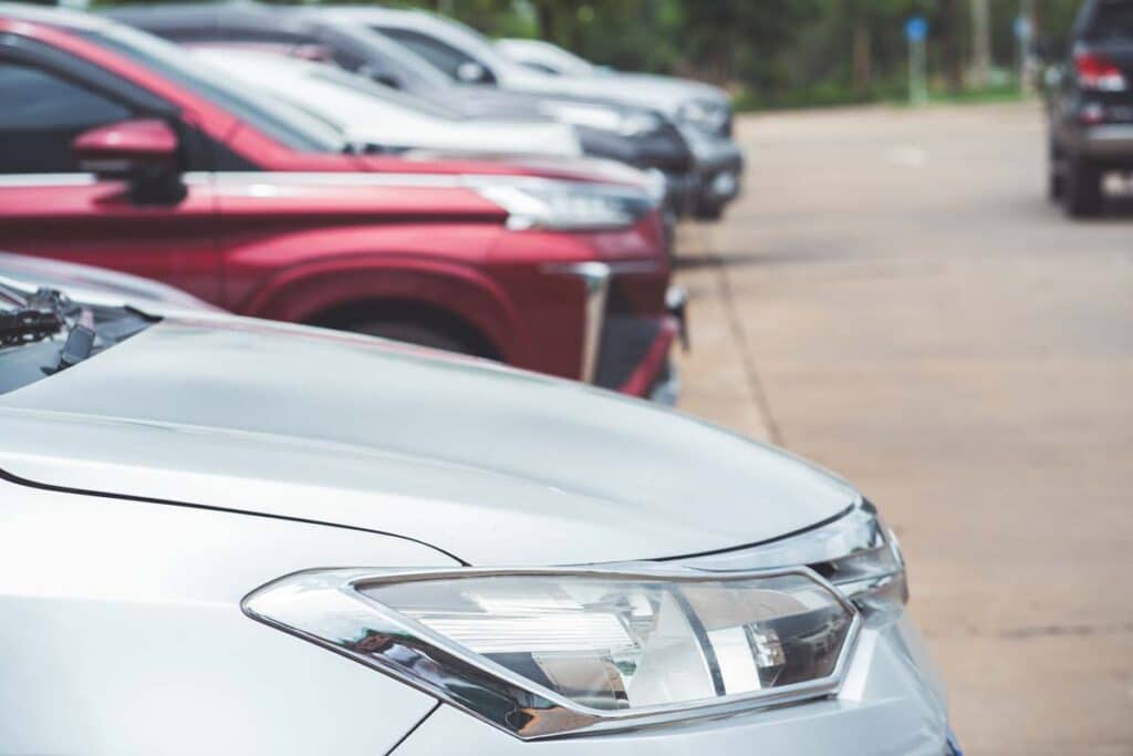 Close up of a row of cars, representing May vehicle recalls.