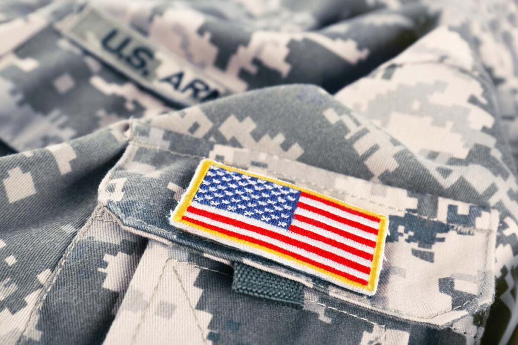 Close up of a U.S. flag patch on an army uniform, representing the veterans and military class actions.