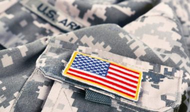 Close up of a U.S. flag patch on an army uniform, representing the veterans and military class actions.