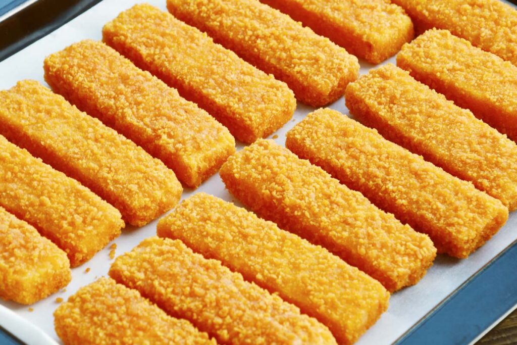 Close up of frozen fish sticks on a cooking tray, representing the frozen fish class action.