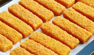 Close up of frozen fish sticks on a cooking tray, representing the frozen fish class action.