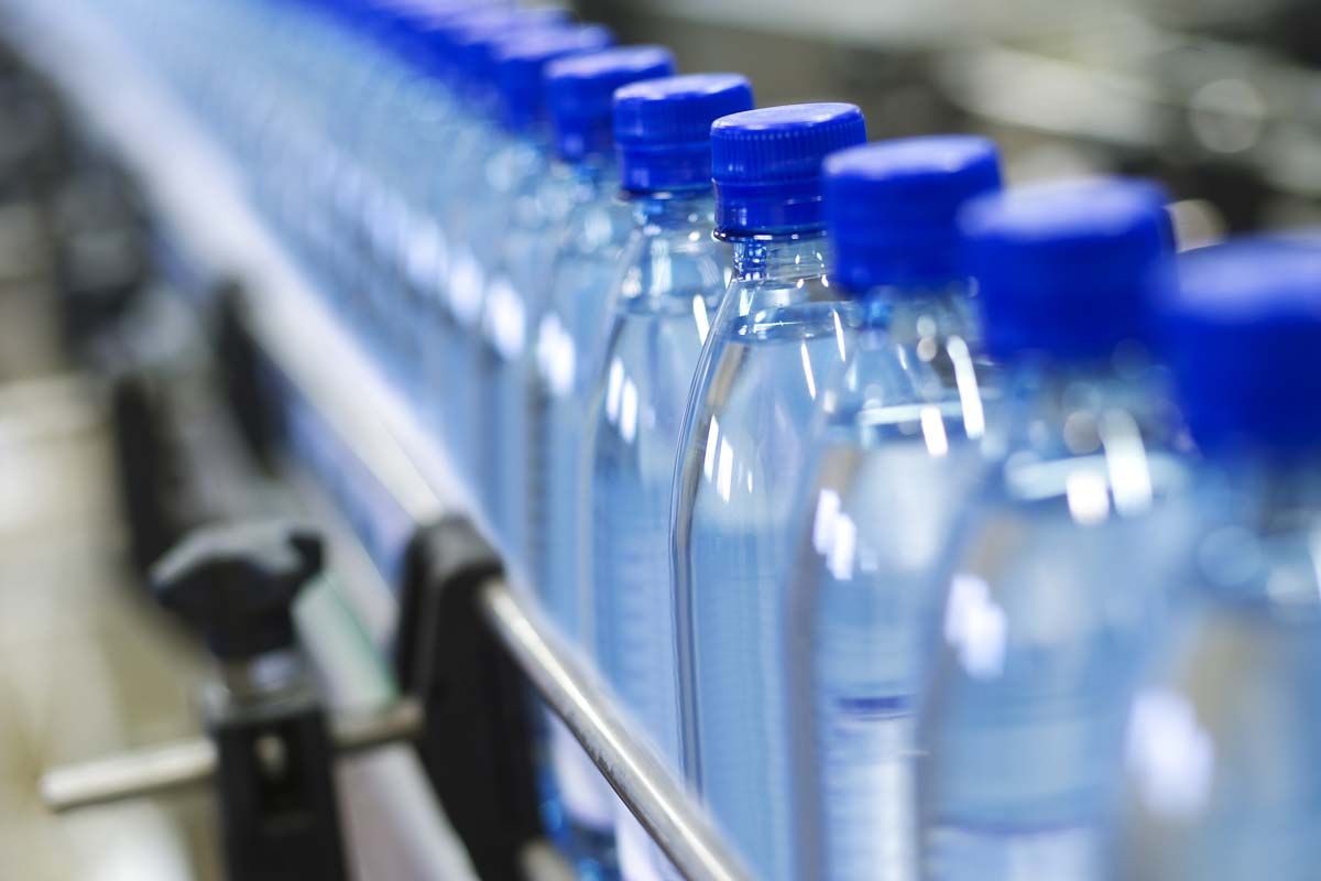 Close up of water bottles on a manufacturing line, representing the Real Water trial.
