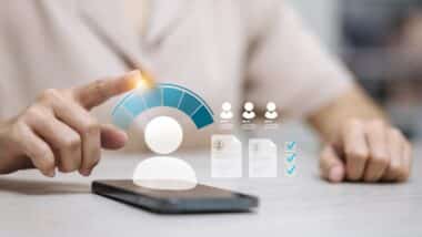 Hand pointing credit score rating with customer profile evaluation on smartphone
