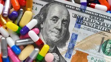 Pills on money dollars - Medicine prescription drugs cost concept
