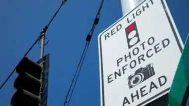 Low angle view on a Photo Enforced Red Light Camera sign