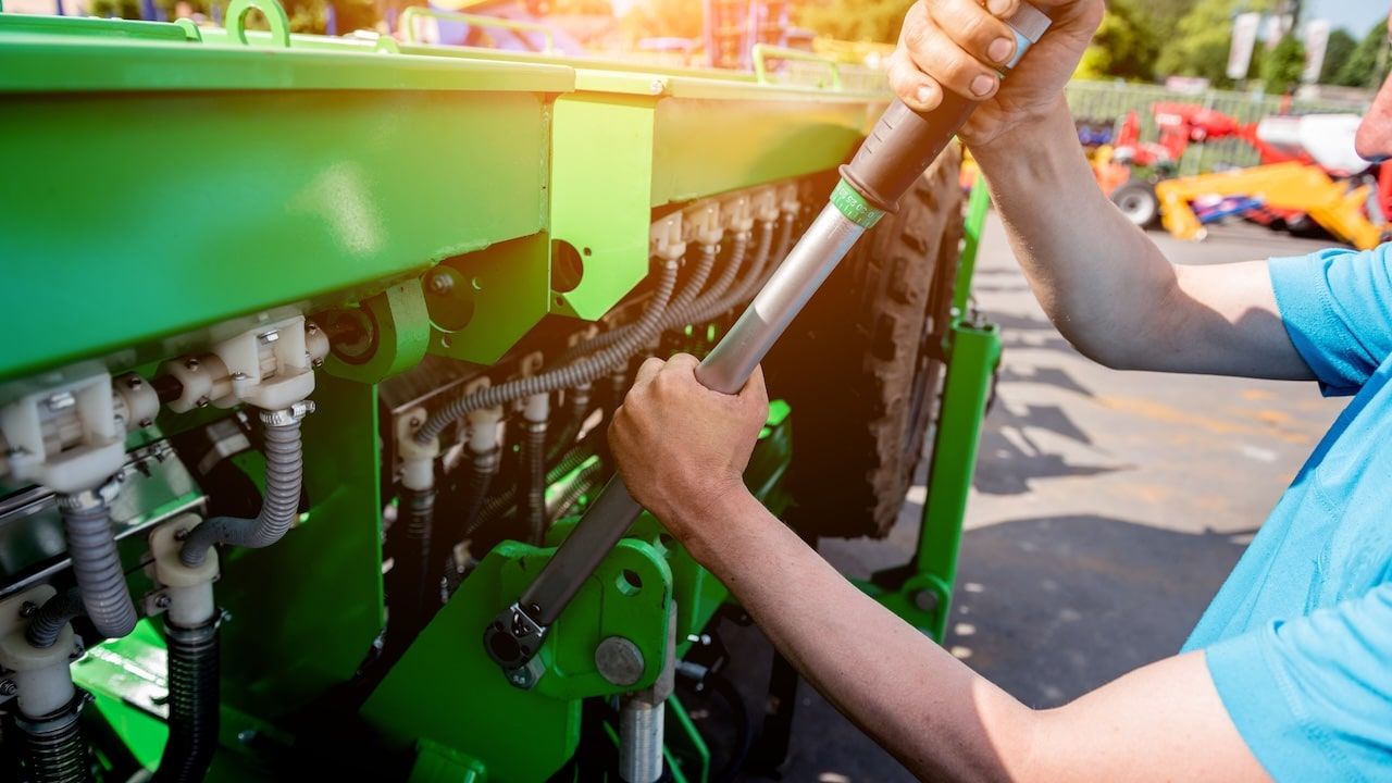 The mechanics repair combine harvester. Modern agricultural machinery