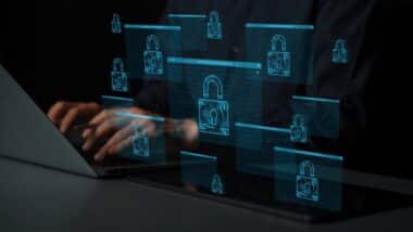 Hands Typing on Laptop with Digital Lock Icons Representing Cybersecurity and Data Protection Concepts
