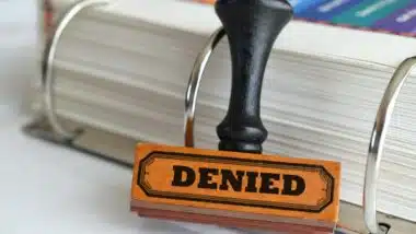 Rubber stamp with word Denied on it.
