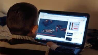 a kid watching videos on laptop.