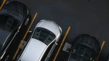 Row of car parking on asphalt lane in modern condominium aerial view