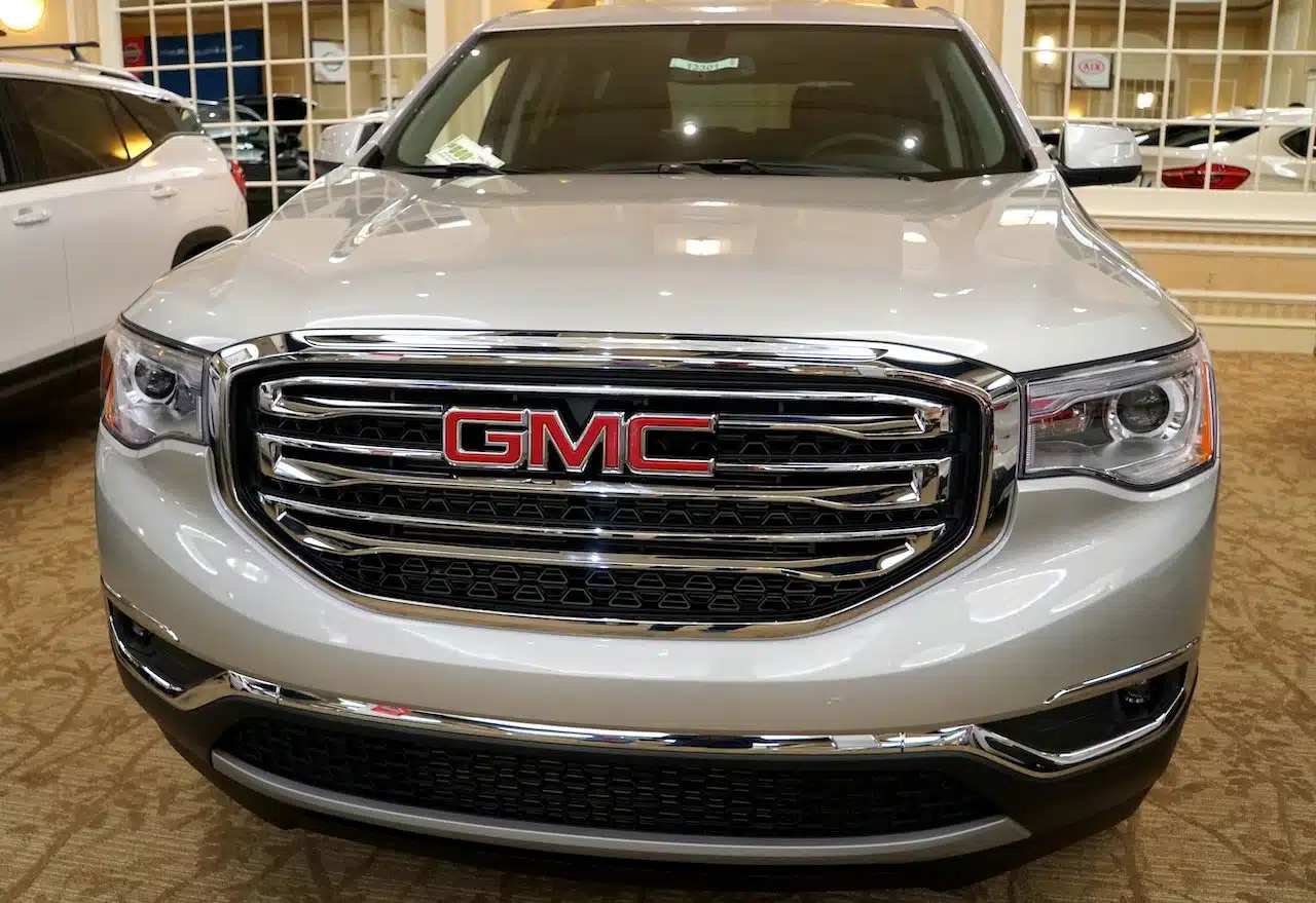 The front view of a brand new 2019 GMC Acadia SLE in white color.