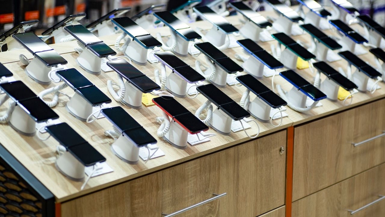 Smartphones store. Showcase with selling various new smartphones in electronics store during a sale.