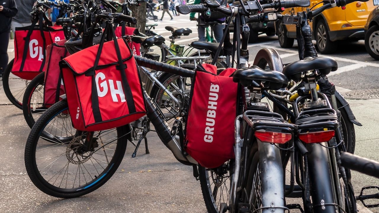 Delivery bicycles with a GrubHub branded totes
