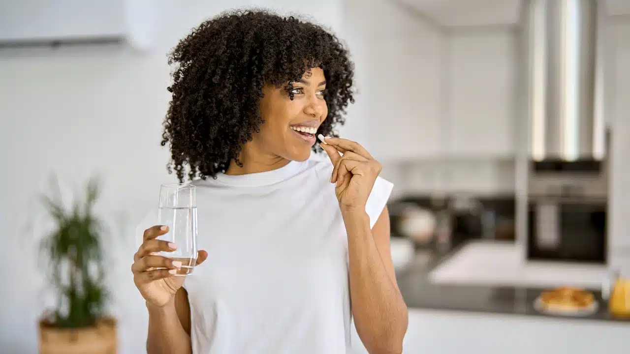 woman taking Keto supplement