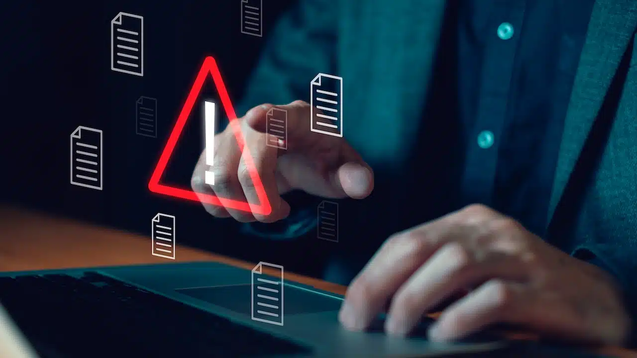 Close up shot of people point to access to personal data and document with warning sign as concept of data breach or attack from hacker or spyware. Data security concept.