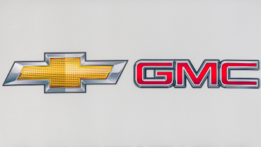 Close up of Chevy GMC pre owned car lot, representing the GM fuel pump settlement.