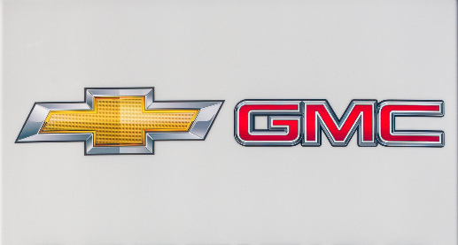 Close up of Chevy GMC pre owned car lot, representing the GM fuel pump settlement.