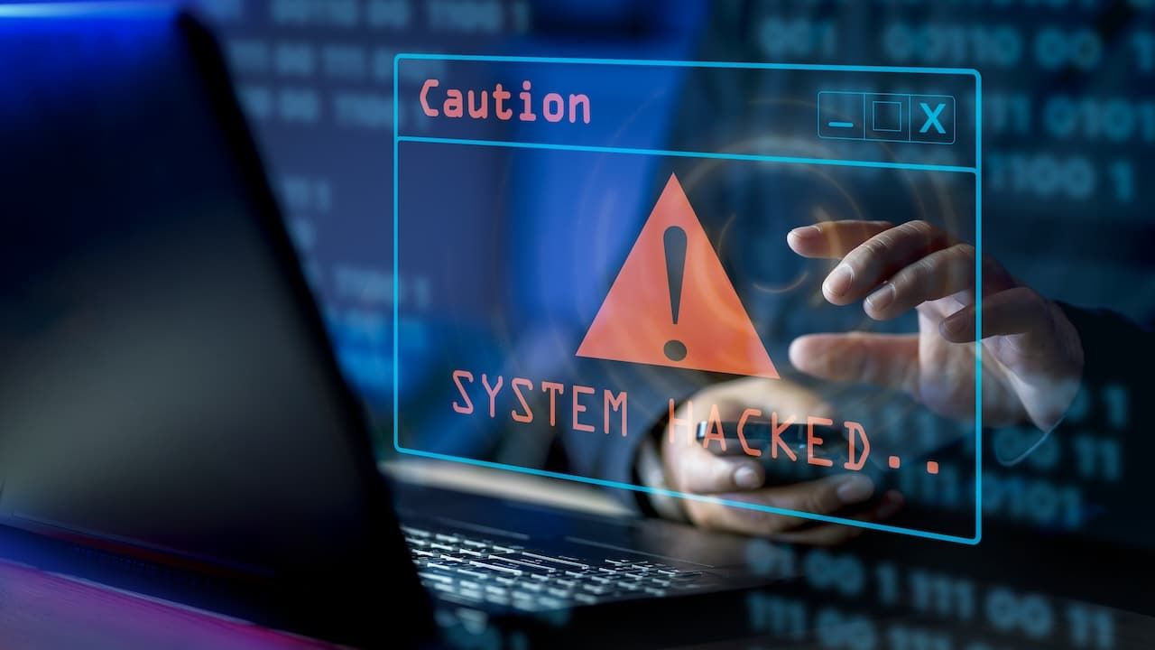 A computer popup box screen warning of a system being hacked, System hacked alert after cyber attack on computer network.