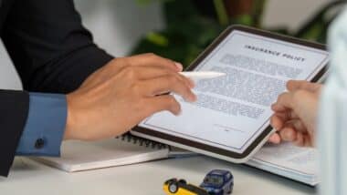 Insurance Consultation. Discussing car insurance policy details with a client.