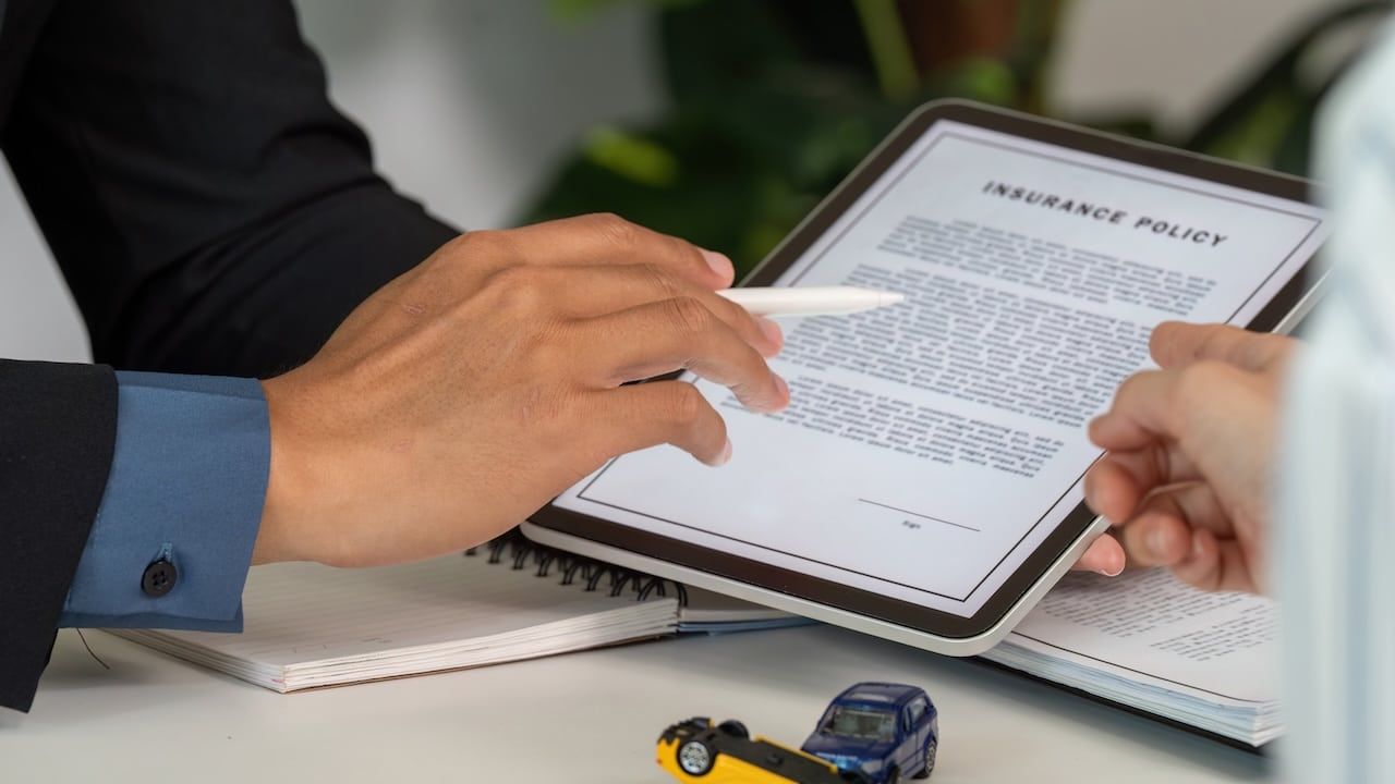 Insurance Consultation. Discussing car insurance policy details with a client.