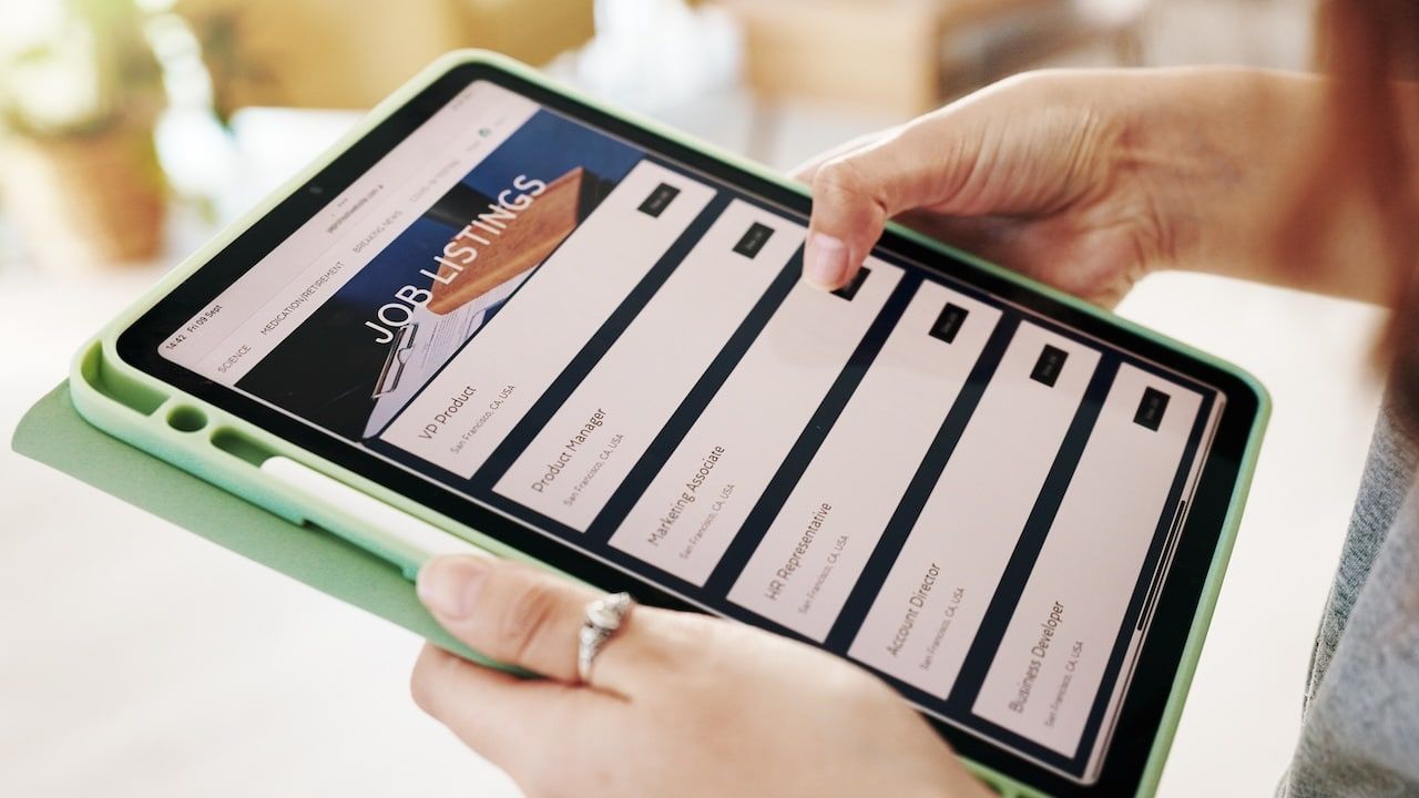 Hands, person and tablet screen for job search on website, vacancy listings and contact us of recruitment process.