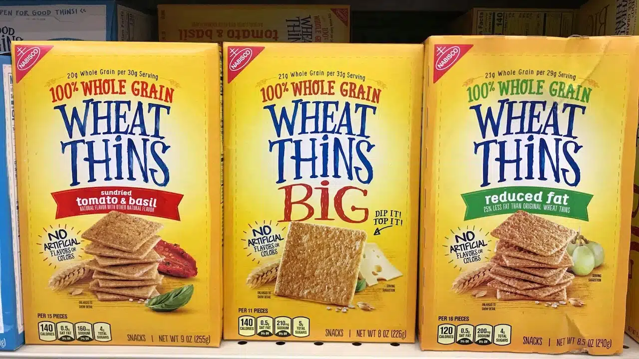 Boxes of Wheat Thins Crackers on Display at the Grocery Store, Wheat Thins is a brand of baked whole grain snack food crackers made by Nabisco.