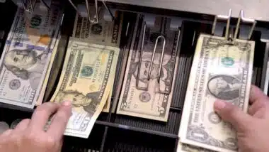 High angle view of cashier searching for change in cash