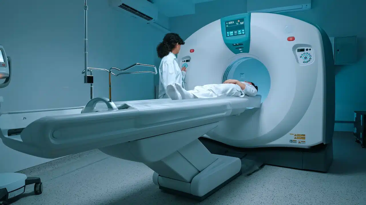 Patient in white clothes undergoes magnetic resonance imaging scan,