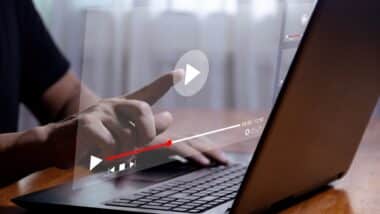 Man using laptop to stream online on virtual screen Streaming video