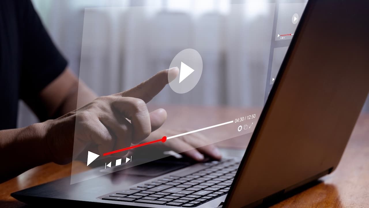 Man using laptop to stream online on virtual screen Streaming video