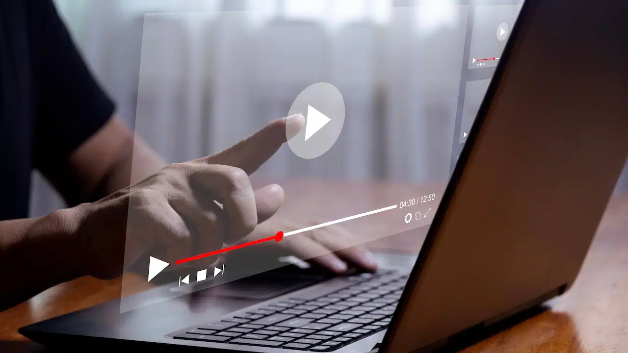 Man using laptop to stream online on virtual screen Streaming video