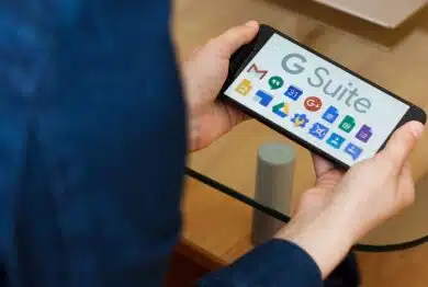 Close up to female hands holding smartphone using G Suite application