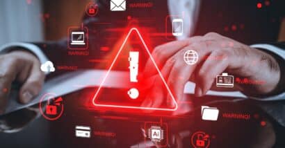 Hands using tablet with red alert icons, glowing modern graphic style on blurred background.