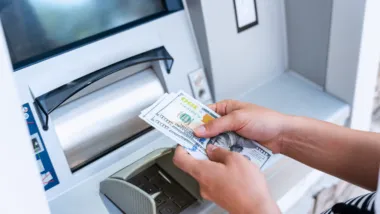 Woman getting money from ATM.