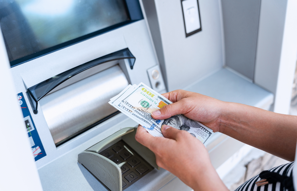 Woman getting money from ATM.